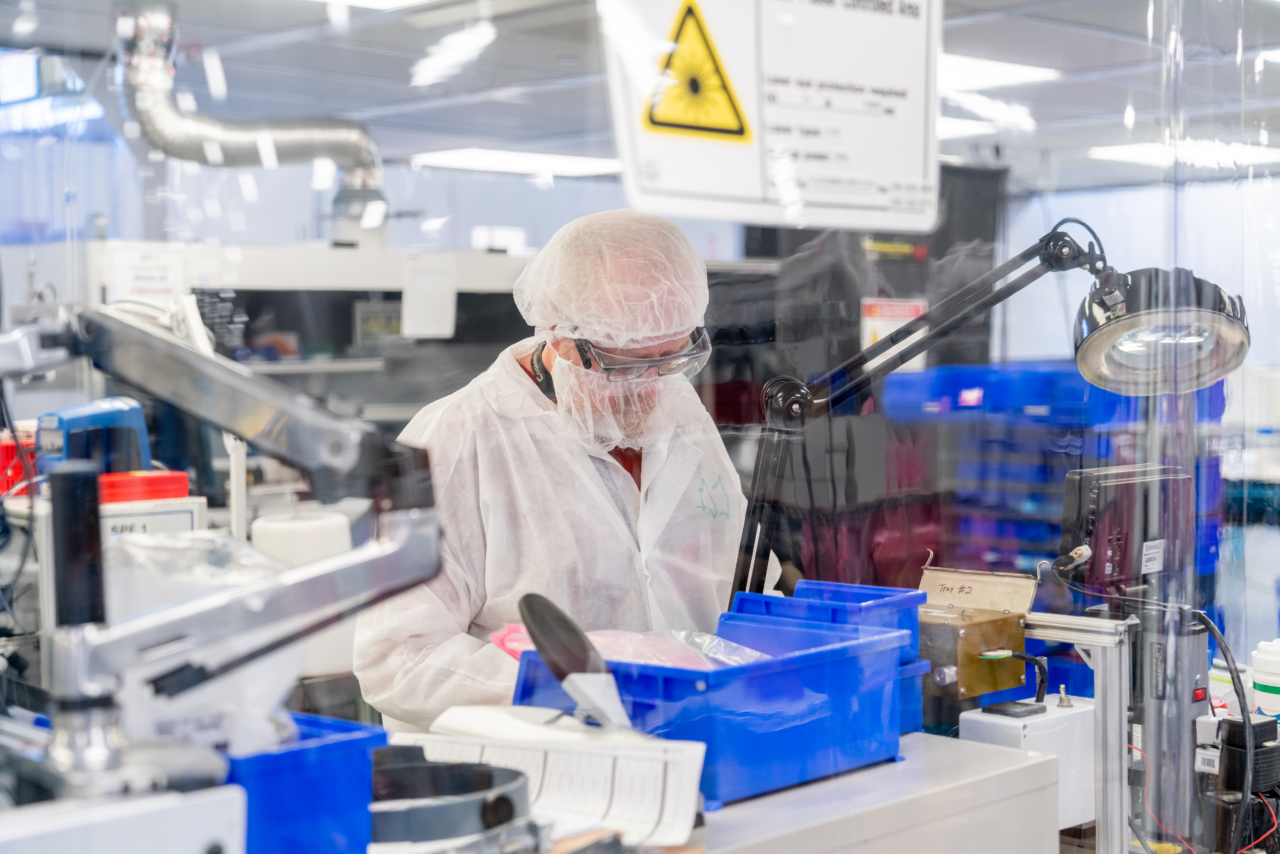 medical device stock Cogmedix Caring Associate wearing PPE working in cleanroom area