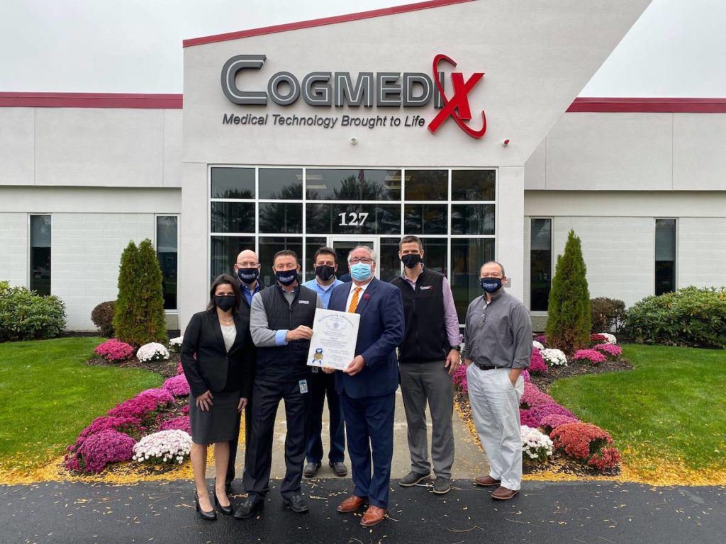 A group of men and women from Cogmedix accepting an award for covid-19 ventilator production.