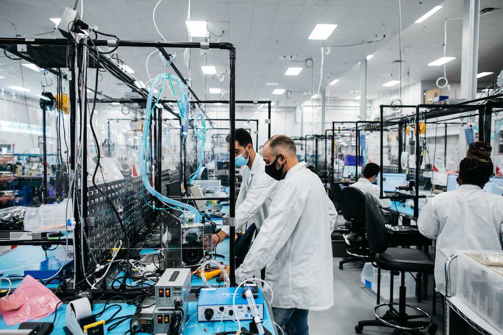 Cogmedix Caring Associates work in separated areas with masks on during industrial design phases of this medical device build.