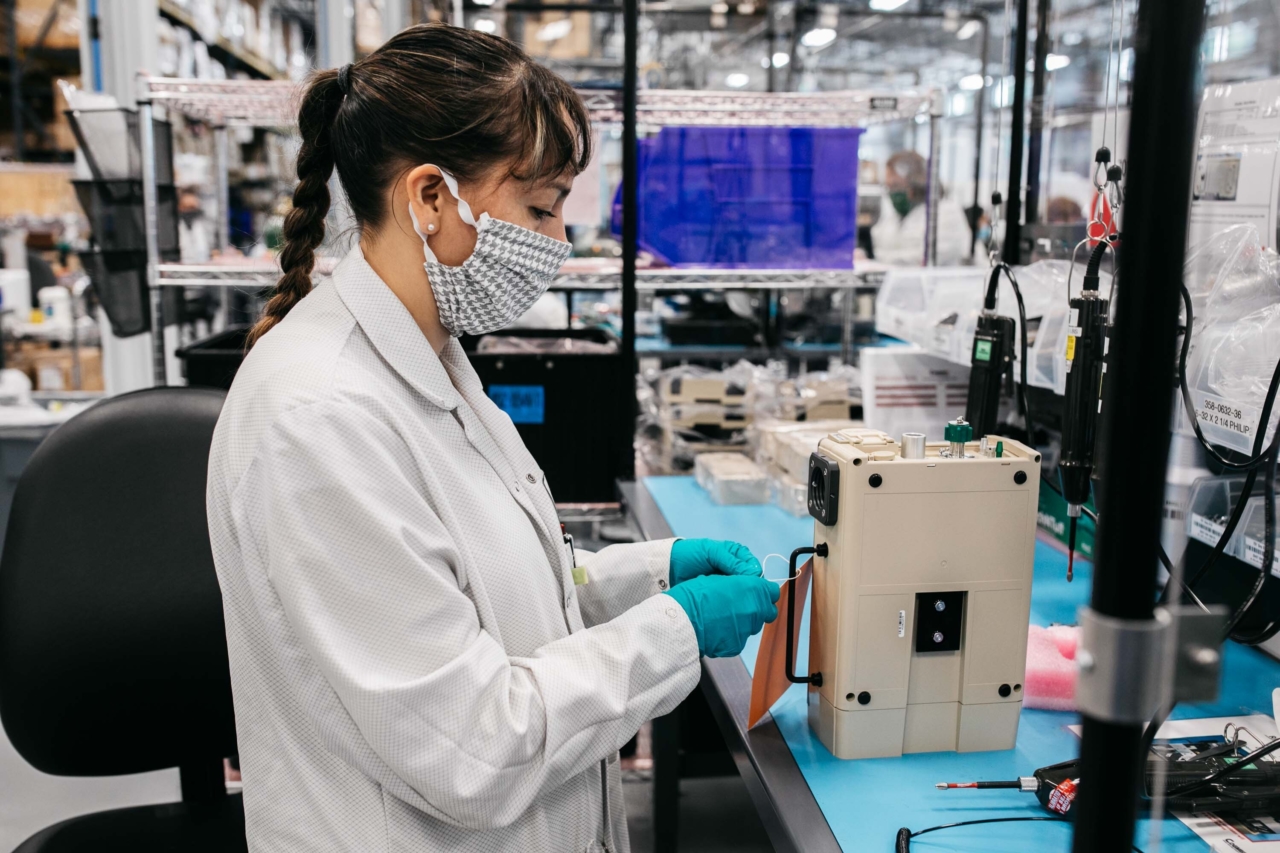 medical-device-manufacuring-assembly An associate at Cogmedix attaches a tag to a medical device.
