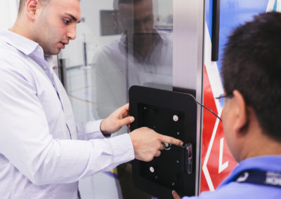 Caring associates at Columbia Tech inspect a control panel during manufacturing.