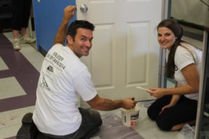 James Neil and Sarah Fisher painting one of many doors and walls